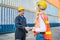 Happy dealing shaking hands two foreman man & woman worker working checking at Container cargo harbor to loading containers. Dock