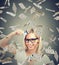 Happy debt free young woman holding a credit card cut in two pieces under money rain