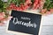 Happy December text on blackboard with flower bouquet decoration