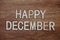 Happy December text message on wooden background