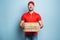 Happy deliveryman happy to delivers pizza with success. Cyan background