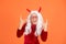 Happy devil kid with party glasses and white hair wear horns costume of imp on halloween party, halloween party fun