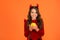 Happy devil teenage girl with pumpkin vegetable wear horns costume of imp on halloween party, halloween