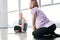 Happy disable girl in activewear looking at friend while both sitting on mats