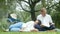 Happy disabled grandfather relaxing with granddaughter outdoor at the park. Family happy lifestyle.