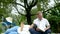 Happy disabled grandfather relaxing with granddaughter outdoor at the park. Family happy lifestyle.