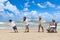 Happy disabled senior elderly woman in wheelchair spend time together with family on tropical beach. Asian grandma, daughter,