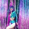 Happy disco Girl 80s in stylish holographic party look and tinsel installation. New year`s clubbing mood. Merry christmas. Holida