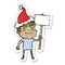 happy distressed sticker cartoon of a man with placard wearing santa hat