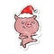 happy distressed sticker cartoon of a pig dancing wearing santa hat