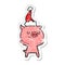 happy distressed sticker cartoon of a pig wearing santa hat