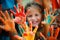 Happy diverse children raising painted hands kindergarten child kids playing playful joyful enjoying colorful paint