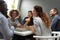 Happy diverse colleagues having fun, enjoying pizza in office