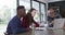 Happy diverse couple and male financial advisor using laptop and smiling at home,slow motion