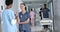 Happy diverse female doctors talking in hospital corridor, slow motion