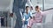 Happy diverse female doctors talking in hospital corridor, slow motion