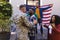 Happy diverse friends with flags welcoming home male soldier friend