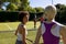 Happy diverse group of friends playing tennis at tennis court