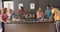 Happy diverse group of friends preapring meal in kitchen, slow motion