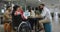 Happy diverse male and female business colleagues and disabled businesswoman talking in office