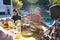 Happy diverse male and female friends eating thanksgiving celebration meal in sunny garden