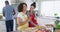 Happy diverse male and female friends making pizza, cooking in kitchen, in slow motion