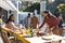 Happy diverse male and female friends serving thanksgiving celebration meal in sunny garden