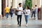 Happy diverse students walking in college campus