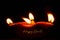 Happy Diwali - Clay Diya lamps lit over black background