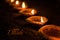 Happy Diwali greeting card design using Beautiful Clay diya lamps lit on diwali night Celebration. Indian Hindu Light Festival ca