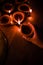Happy diwali - Hand holding or lighting or arranging diwali diya or clay lamp