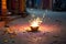 Happy Diwali - Lit diya lamp on street with firecrackers, neural network generated photorealistic image