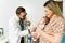 Happy doctor using a stethoscope on a baby