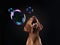 happy dog catches soap bubbles. Hungarian vizsla