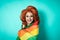 Happy drag queen celebrating gay pride holding rainbow flag