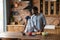 Happy dreamy African American couple cooking in kitchen together