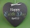 Happy Earth Day April 22, message sign greeting on a heart shaped blackboard