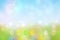 Happy easter background. Abstract green meadow with spring flowers and colorful easter eggs and a sunny blue sky. Space for your