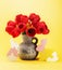 Happy Easter background with beautiful spring bouquet of red tulips in vase and wooden bunnies.