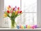 Happy Easter. Bouquet of tulip with colorful easter eggs near window Generative AI