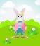A happy Easter bunny is standing on a green field and smiling. Vector illustration for easter cards and greetings.