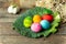 Happy Easter card background - pastel, hand-painted, sweet, colorful Easter eggs on a simple, rustic wooden table
