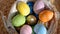 Happy Easter. Close up of painted eggs in a basket rotating in circle. POV.