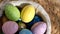 Happy Easter. Close up of painted eggs in a basket rotating in circle. POV.