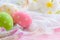 Happy easter! Colorful of Easter eggs in nest with flower, paper star and Feather on white cheesecloth and bright pink pastel