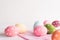 Happy easter! Colorful of Easter eggs with pink and white cheesecloth on wooden background