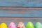Happy easter, colorful easter eggs standing with blue wooden backgrounds, easter holiday decorations concept with copy space