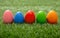 Happy Easter. Colorful eggs on green grass, close up view