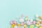 Happy Easter concept. Easter candy chocolate eggs and jellybean sweets isolated on trendy pastel blue background. Simple