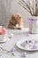 Happy Easter concept. Easter composition, greeting card, poster. Cute cat with easter egg in his paws and meringue nests with eggs